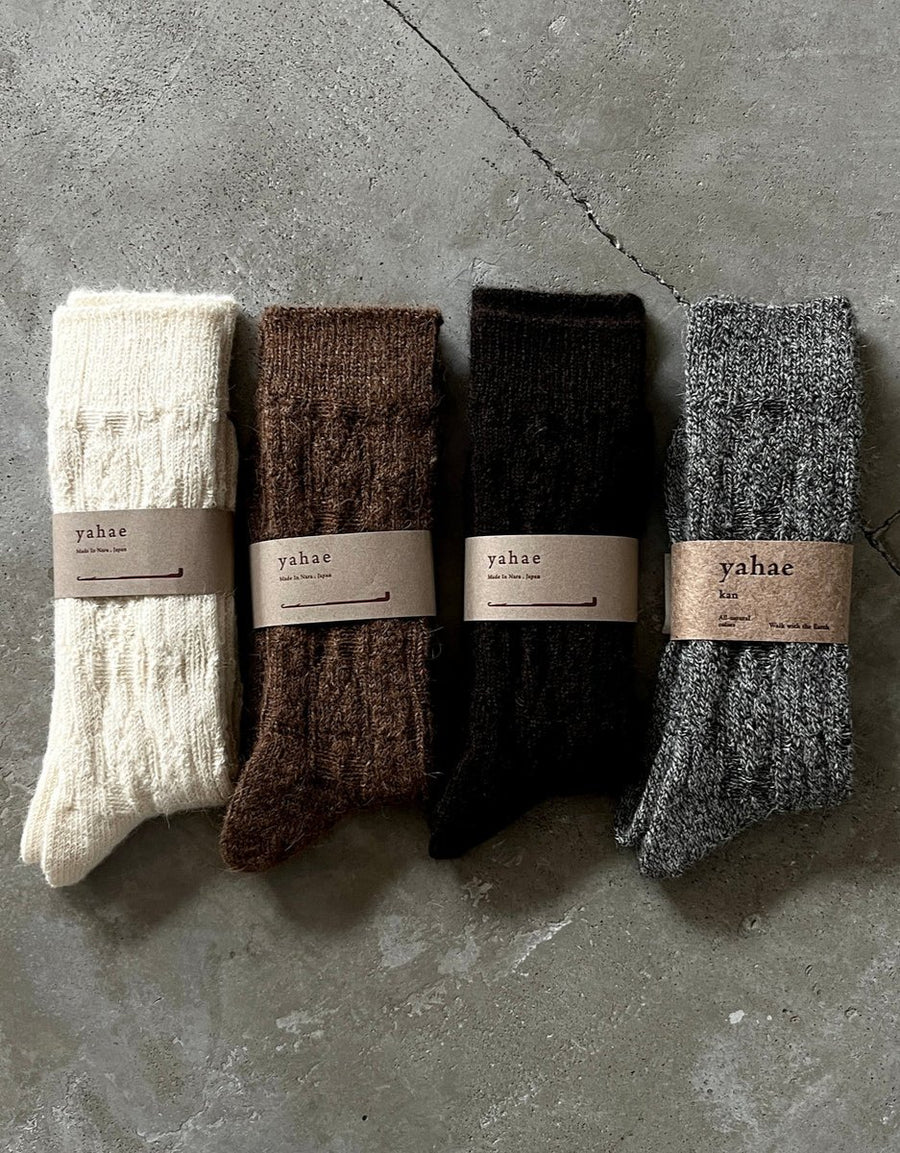 Cable knit socks by Yahae